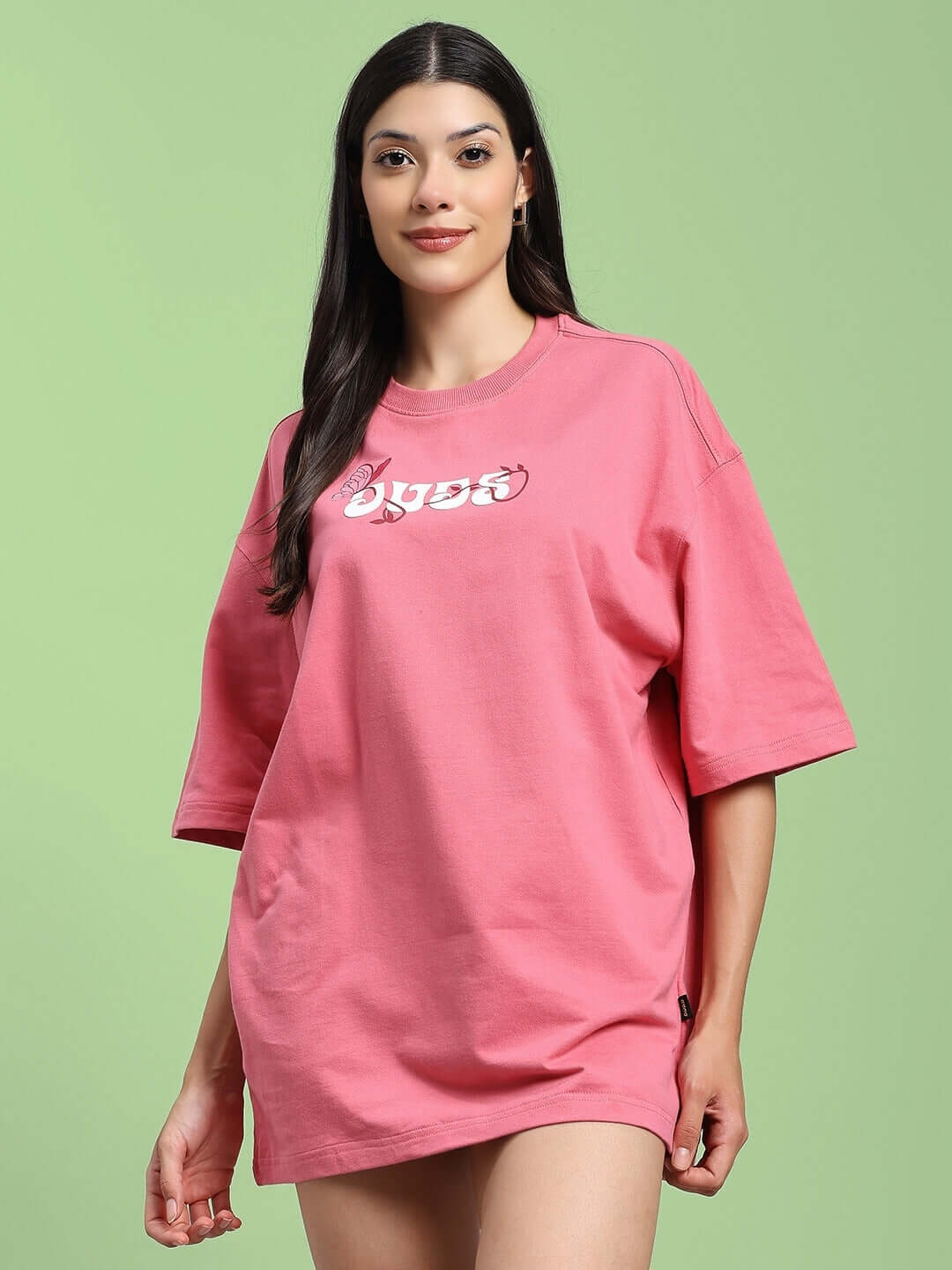 Model wearing pink printed women's t-shirt made of premium cotton French terry, featuring a relaxed fit, by Color By Colours.