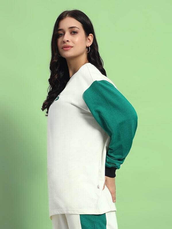 Model wearing WOMEN'S ZINGY OVERSIZED SWEATSHIRT OFF WHITE TEAL, premium cotton fabric, with teal sleeves, side view