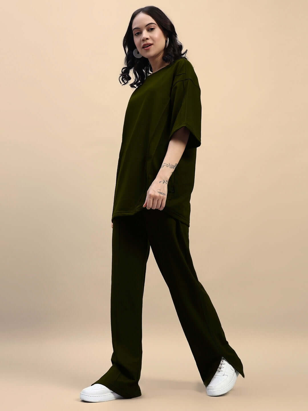Model wearing Women's Zion Relaxed Fit Co-Ord Set in Olive Green, featuring unisex joggers and t-shirt, made of premium cotton blend.