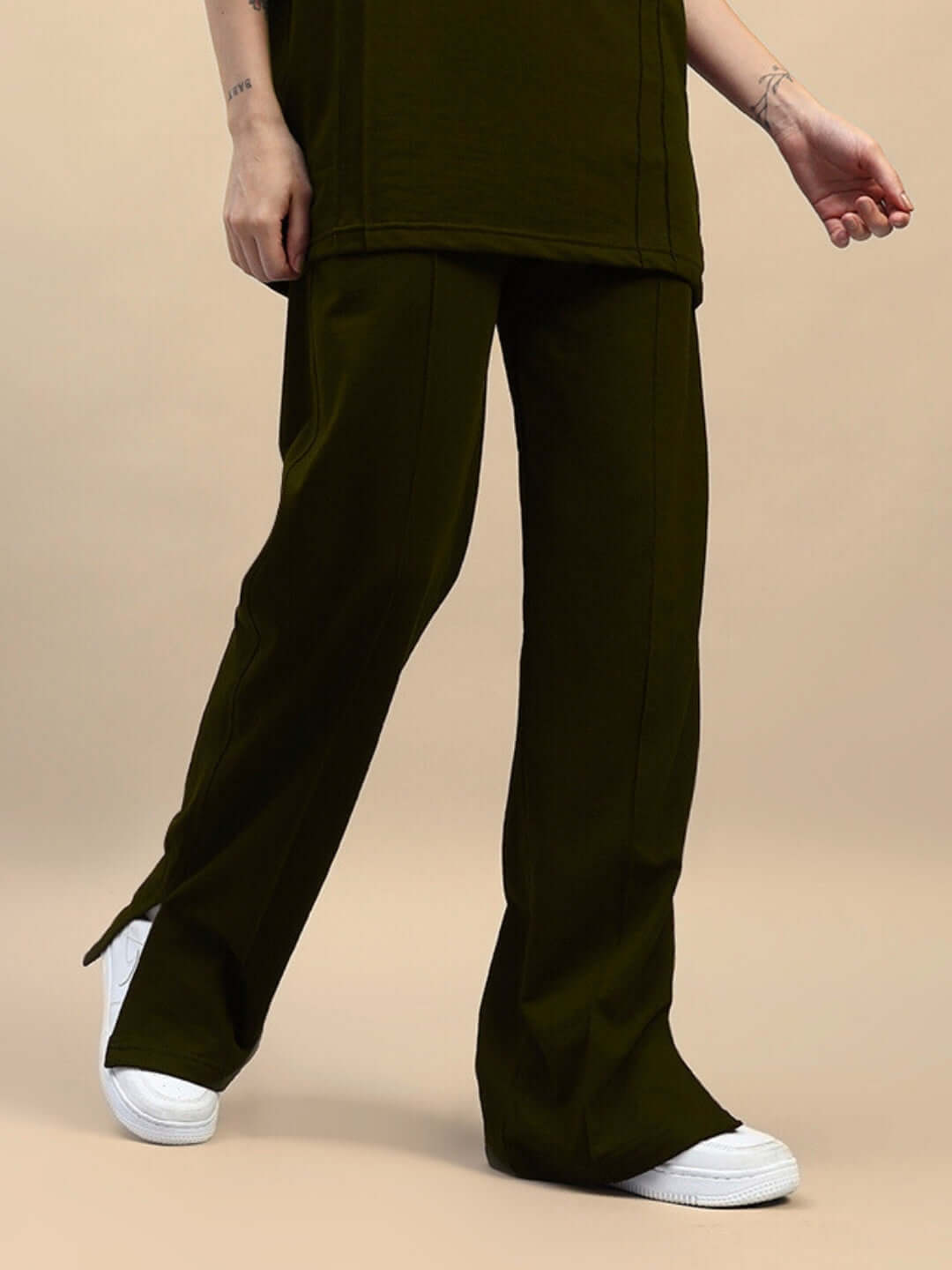Olive green WOMENS ZION SIDE SLIT JOGGERS showcasing side slits, styled with casual sneakers, ideal for athleisure and casual wear.