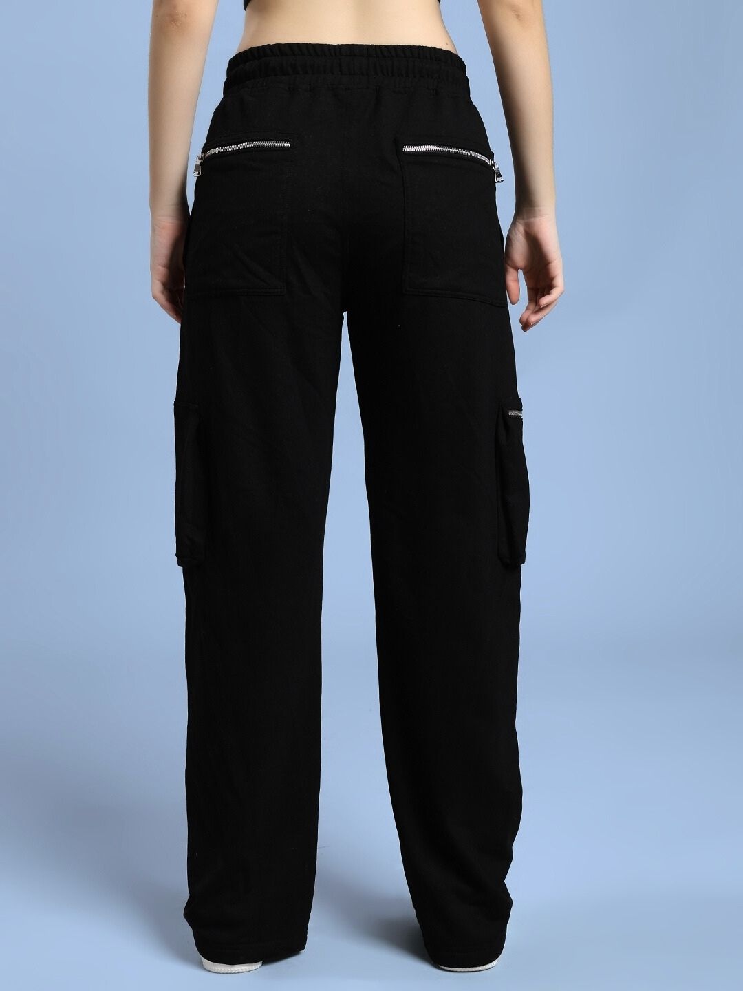 Back view of WOMEN'S ZIP TECH PREMIUM CARGO BLACK pants showing utility-driven style and functionality.