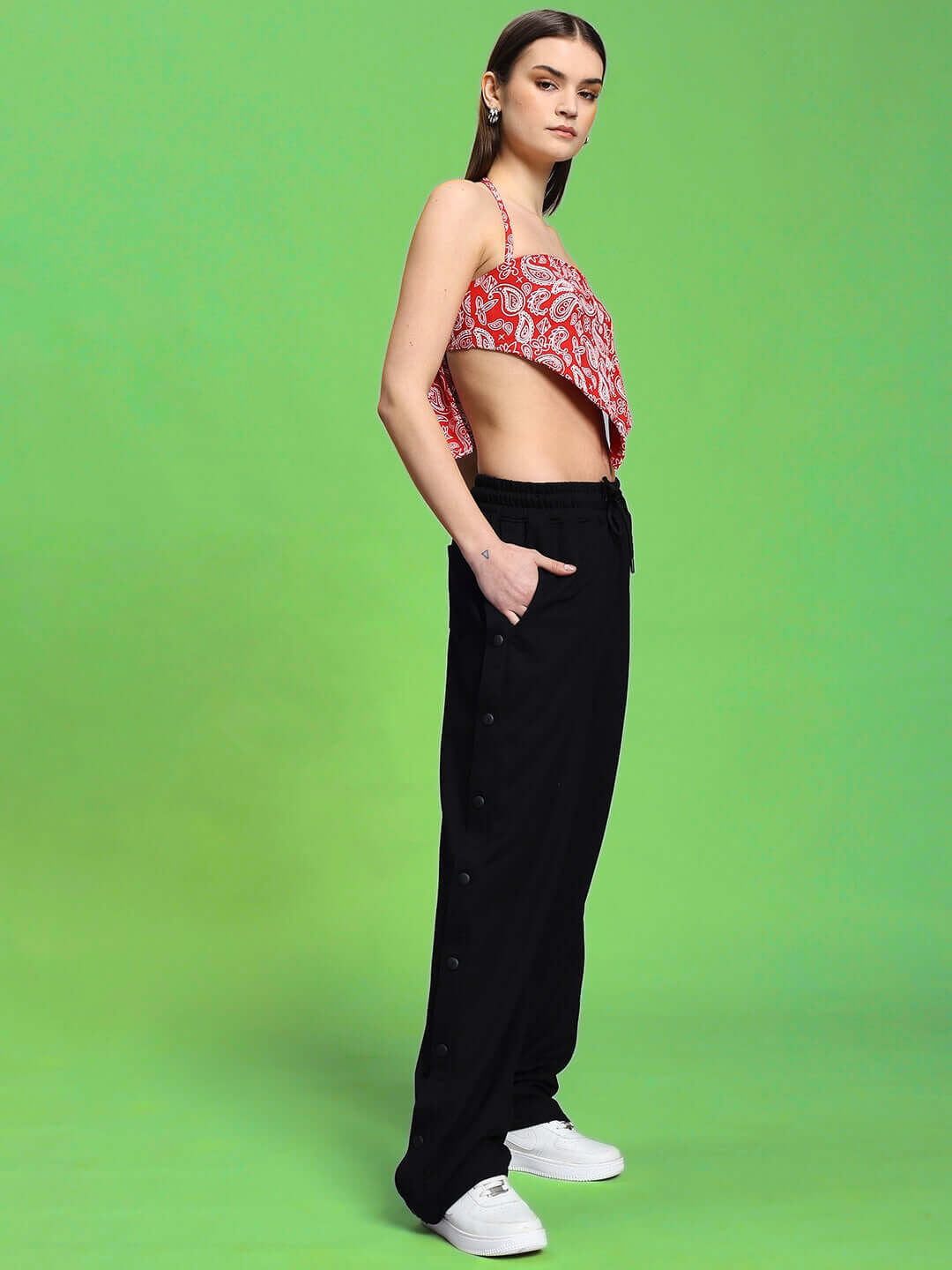 Model showcasing WOMEN'S ZIVA CO-ORD SET RED-BLACK on green background, highlighting bold style and comfort.