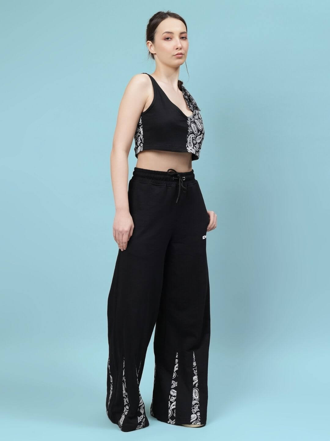 Black women's Ziya co-ord set featuring a sleeveless top and wide-leg pants, displayed on a model against a light blue background.