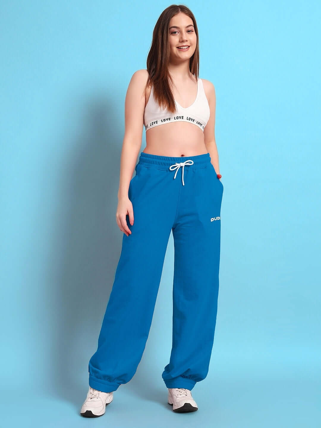 Model wearing women's Austrian relaxed-fit blue joggers from DUDS, showcasing comfortable and stylish made-to-order apparel.