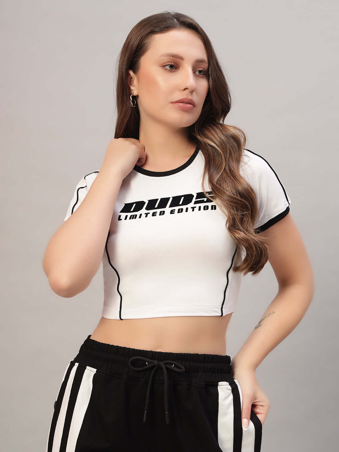 Model wearing WOMEN'S BANDIT CROP-TOP in white, made of premium heavy gauge 100% cotton fabric, showcases casual elegance and style.