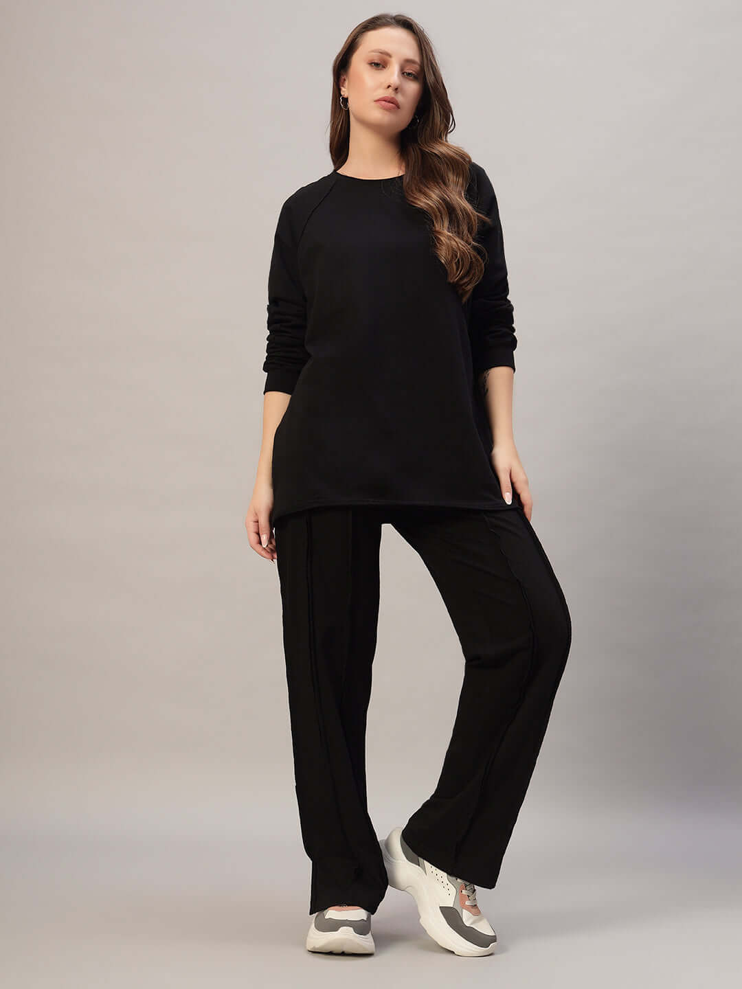Woman wearing Women's Lamina Oversized Co-Ord Set in black, featuring a relaxed fit with joggers and a drawstring waist.