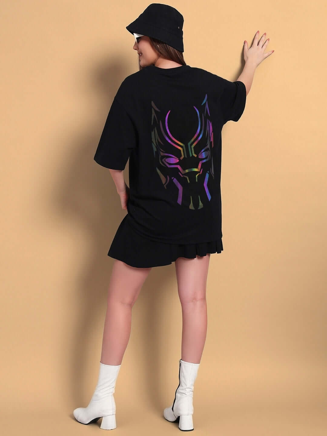 Woman wearing women's Black Panther oversized t-shirt with reflector design, posing from the back. Premium fabric, 97% cotton.