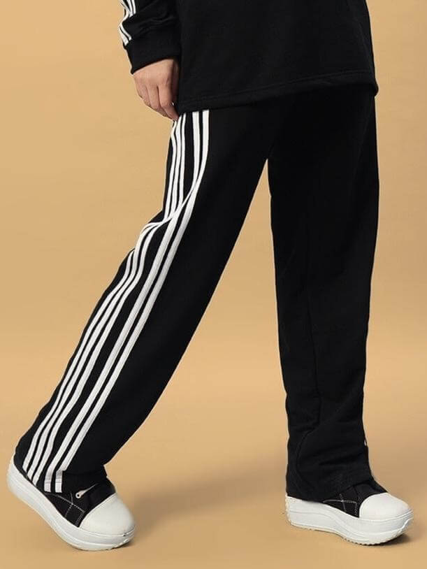 Black women's parka joggers with white stripes, made to order by DUDS, featuring a customizable fit option for prepaid orders.