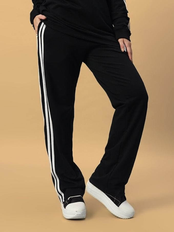 Black women's parka jogger pants with white stripes, featuring a comfortable and customizable fit, designed for versatile wear.