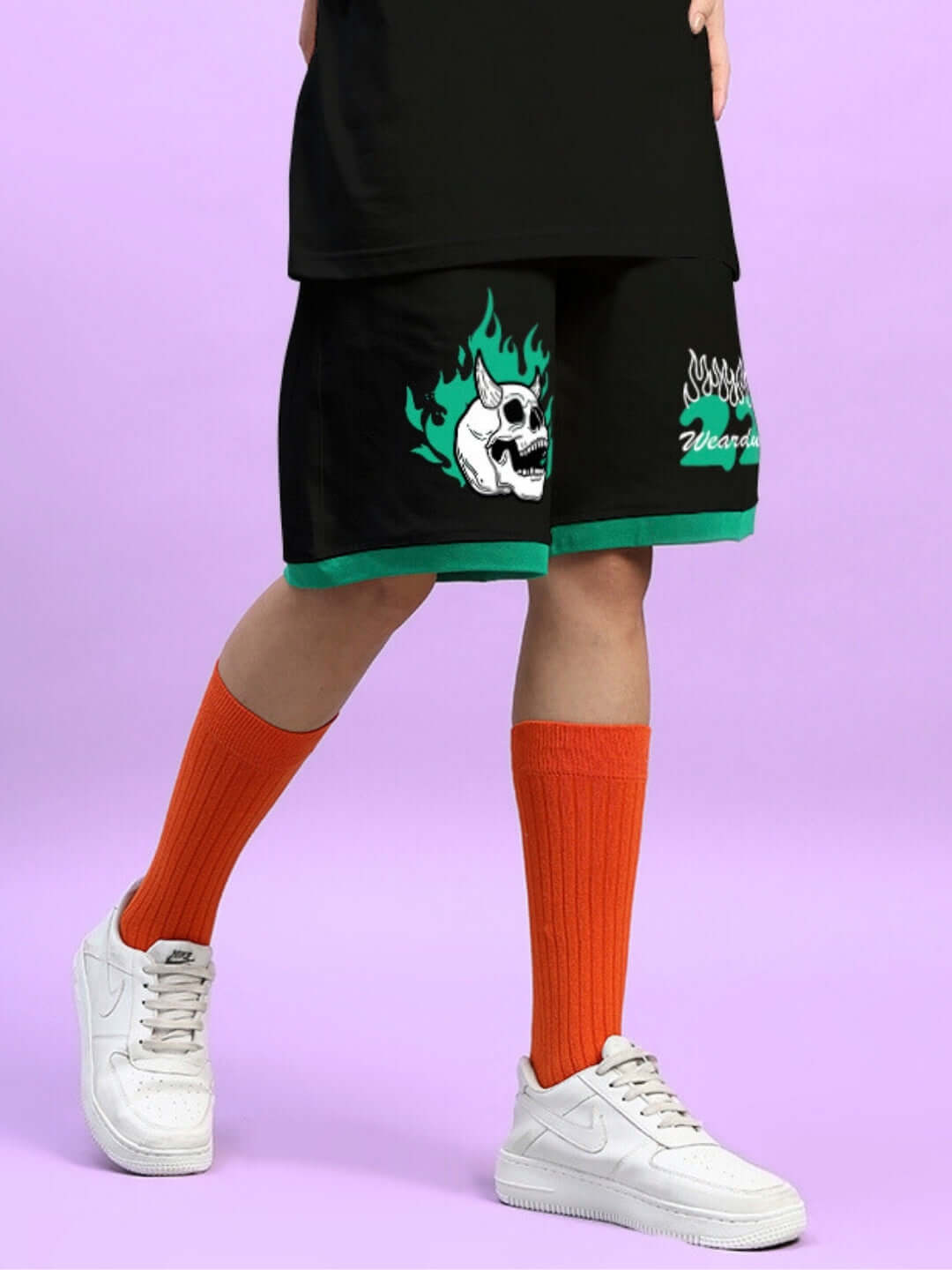 Black women's summer shorts with skull and flame design, paired with orange socks and white sneakers.