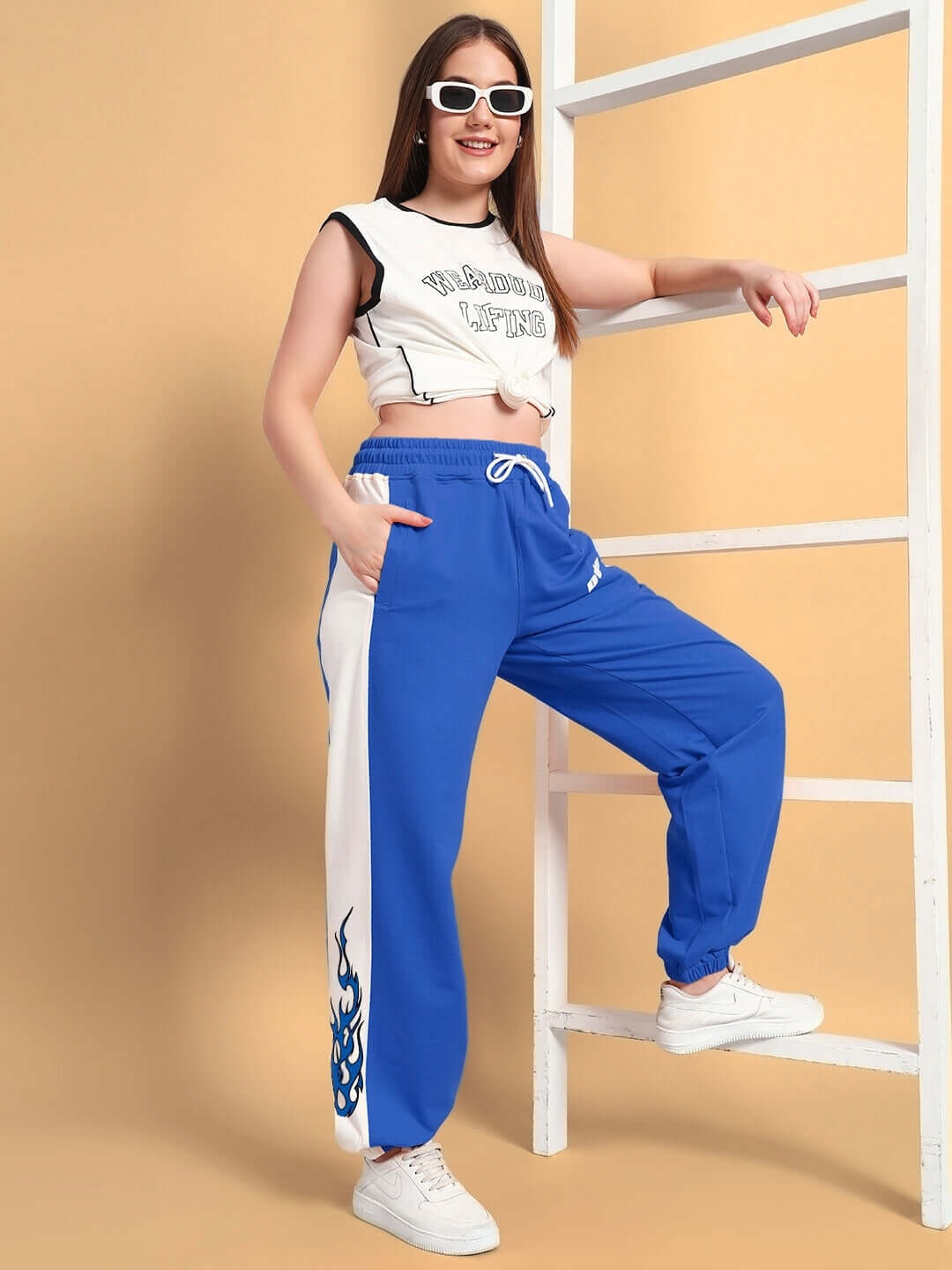 Woman wearing WOMENS BRACER RELAXED FIT JOGGERS BLUE-WHITE, casual style with soft, breathable fabric for comfort and ease.