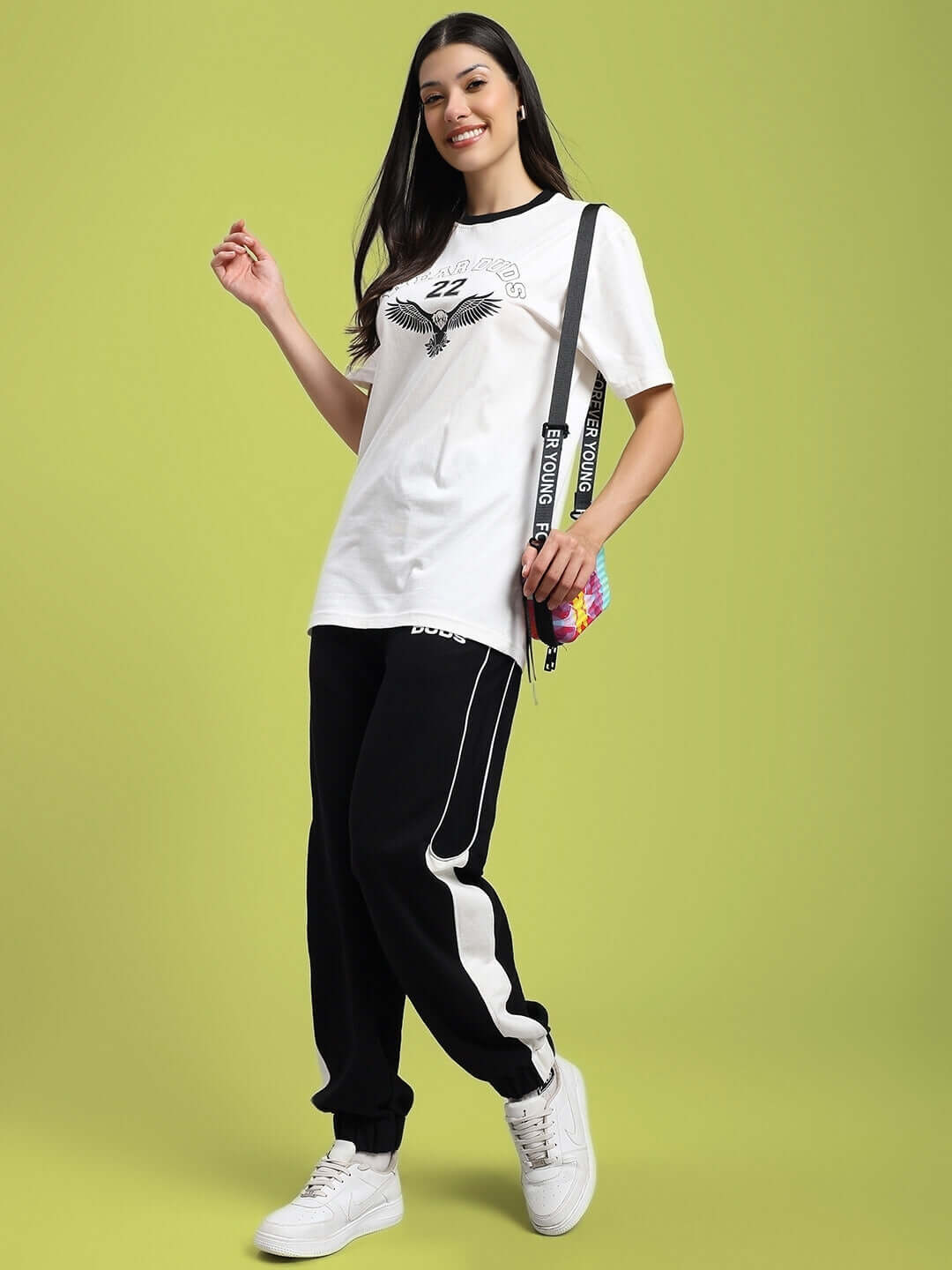 Woman wearing WOMENS DENVER RELAXED FIT JOGGERS BLACK with white sneakers, showcasing a stylish and comfortable look.