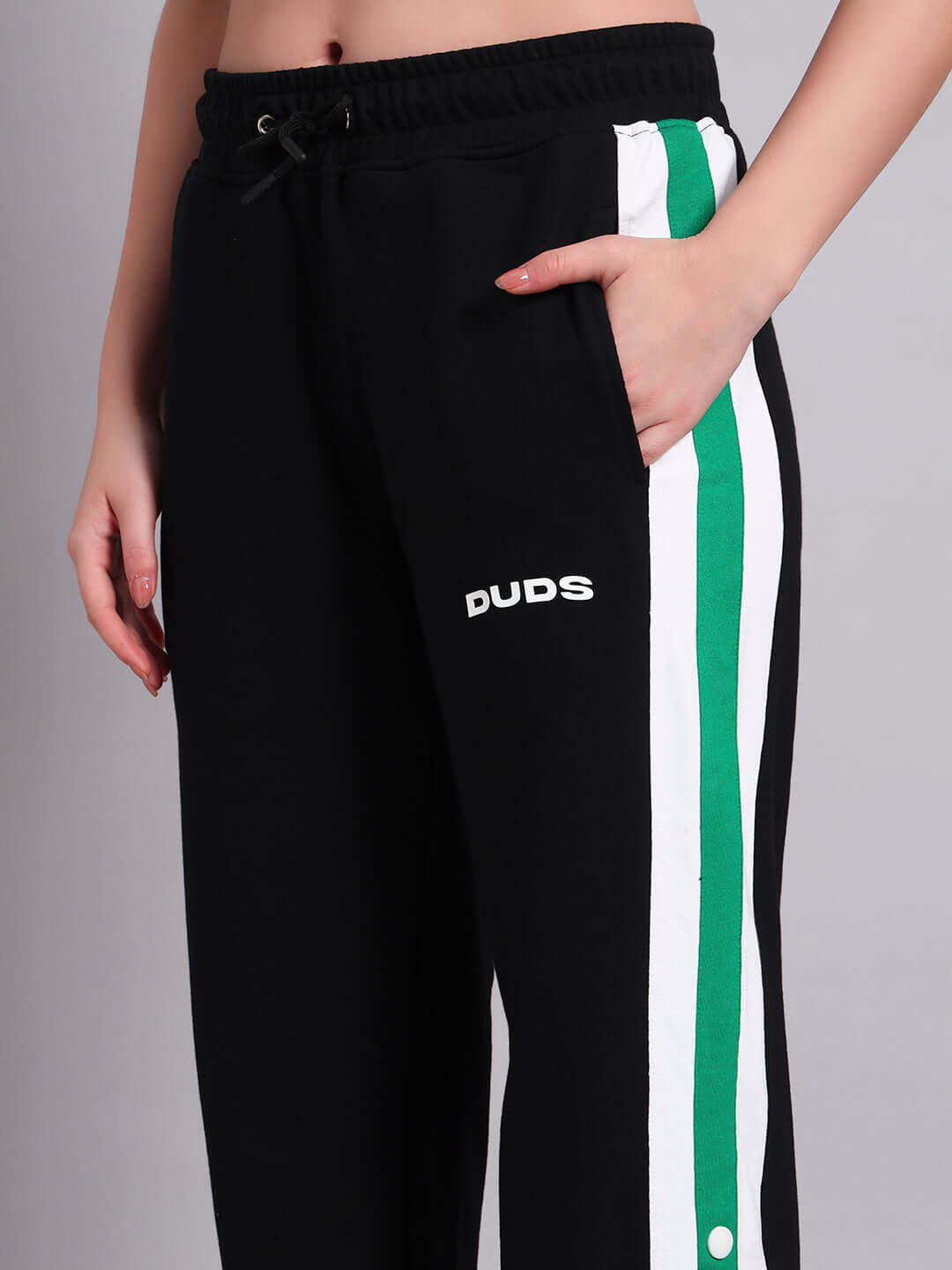 Women's black joggers with Emirati green stripes, featuring the DUDS logo. Ideal for customization and tailored fit options.