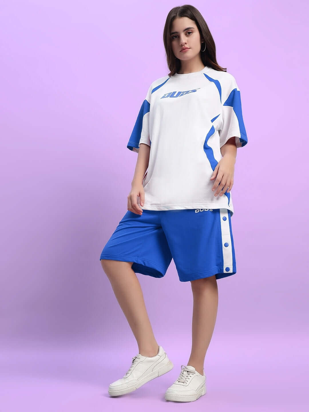 Model wearing Women's Ezel Regular Fit Blue Shorts paired with a white and blue top, showcasing sporty and comfortable activewear style.