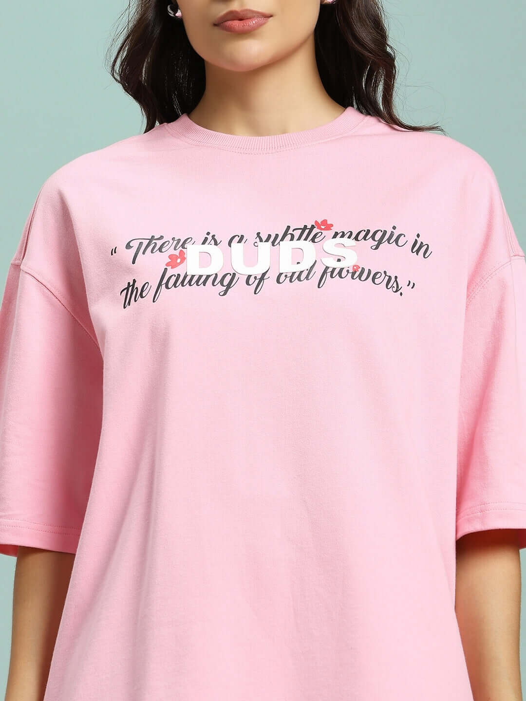 Pink women's t-shirt made from premium cotton French terry with falling flower motif, featuring stylish quote design. Ideal for casual wear.