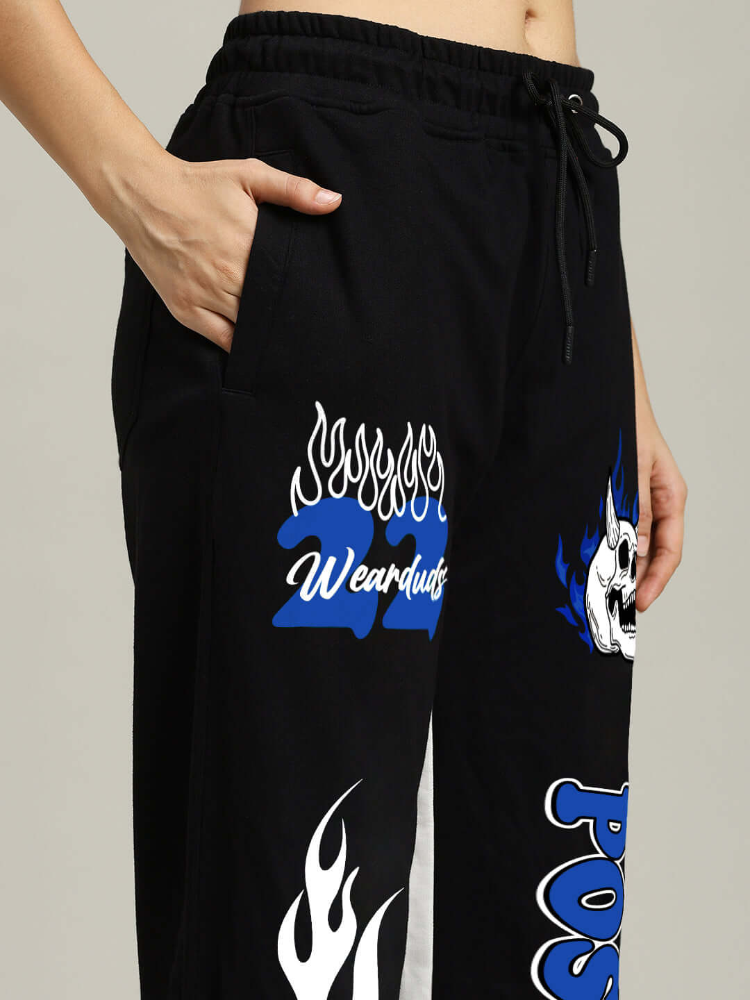 Close-up of WOMEN'S FEARLESS POSITIVE RELAXED FIT JOGGERS BLACK-BLUE with side pockets and bold graphics