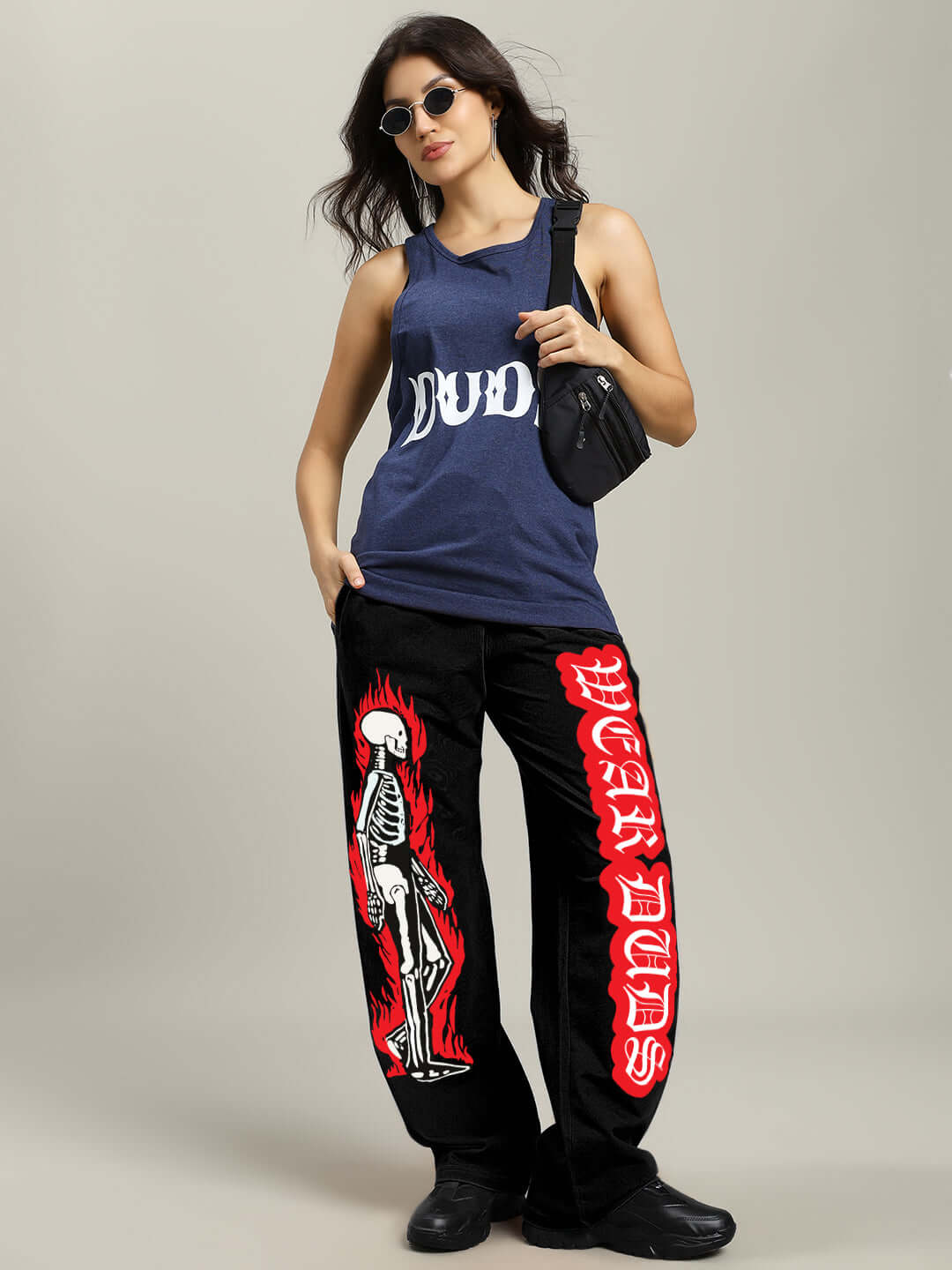 Woman wearing WOMENS FLAMING SKELETON PRINTED RELAXED FIT JOGGER BLACK with edgy streetwear style.