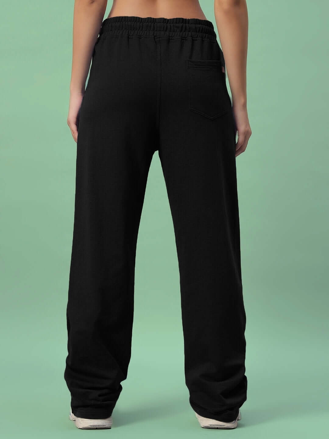 Back view of WOMEN'S HERSHEY SIDE SLIT JOGGERS in black, featuring a comfortable fit with tailored finish and elastic waistband.
