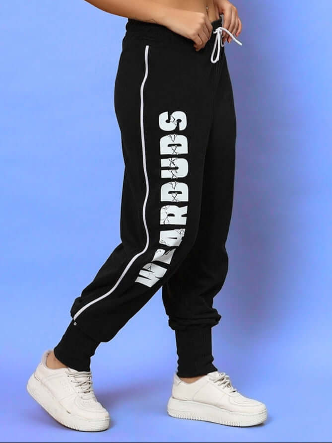 Women's black hunter joggers by DUDS, featuring white lettering on the side, paired with sneakers. Custom fit available.