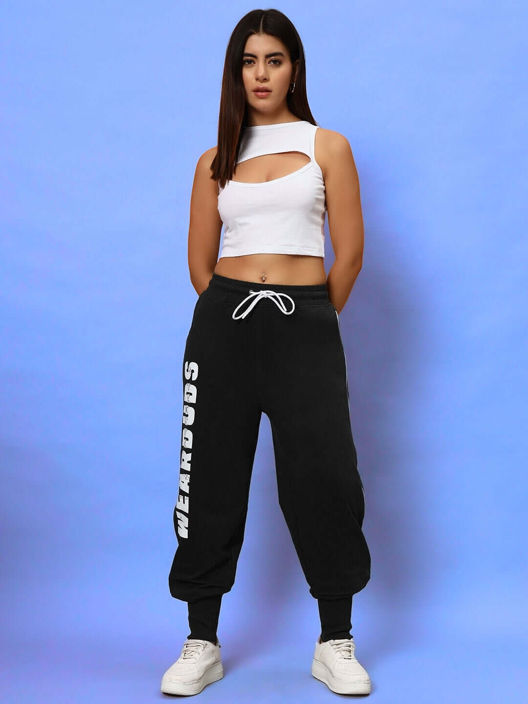 Model wearing Women's Hunter Joggers in Black by DUDS, featuring a casual fit and bold white text down the leg.