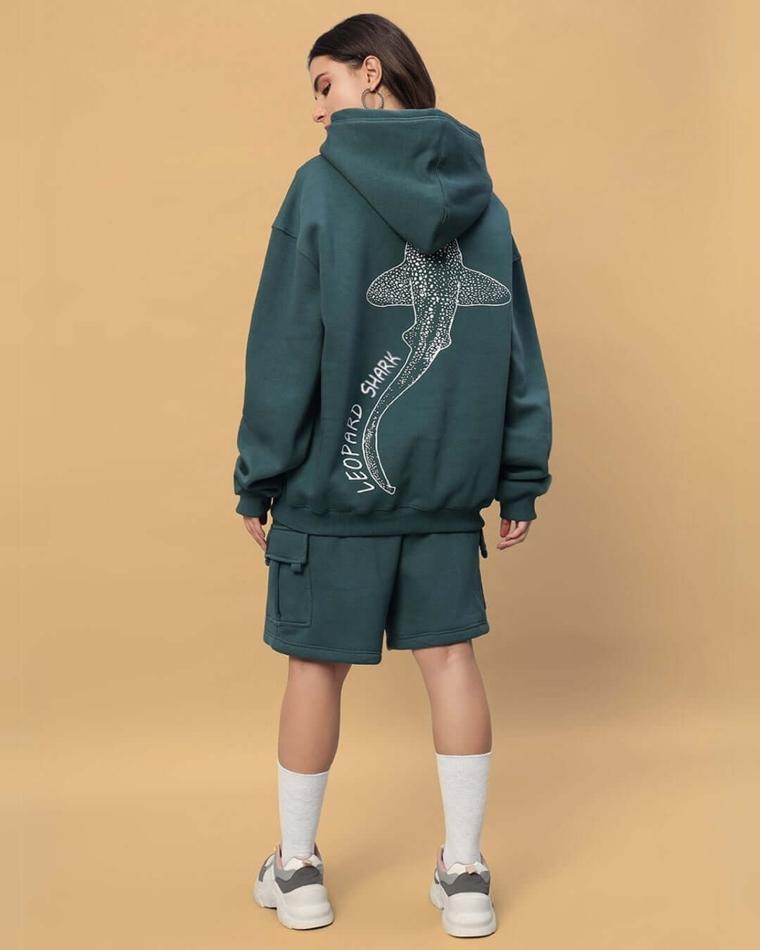 Back view of woman wearing WOMEN'S LEOPARD SHARK FLEECE CO-ORD TEAL GREEN from DUDS, showcasing detailed shark design on the hoodie.