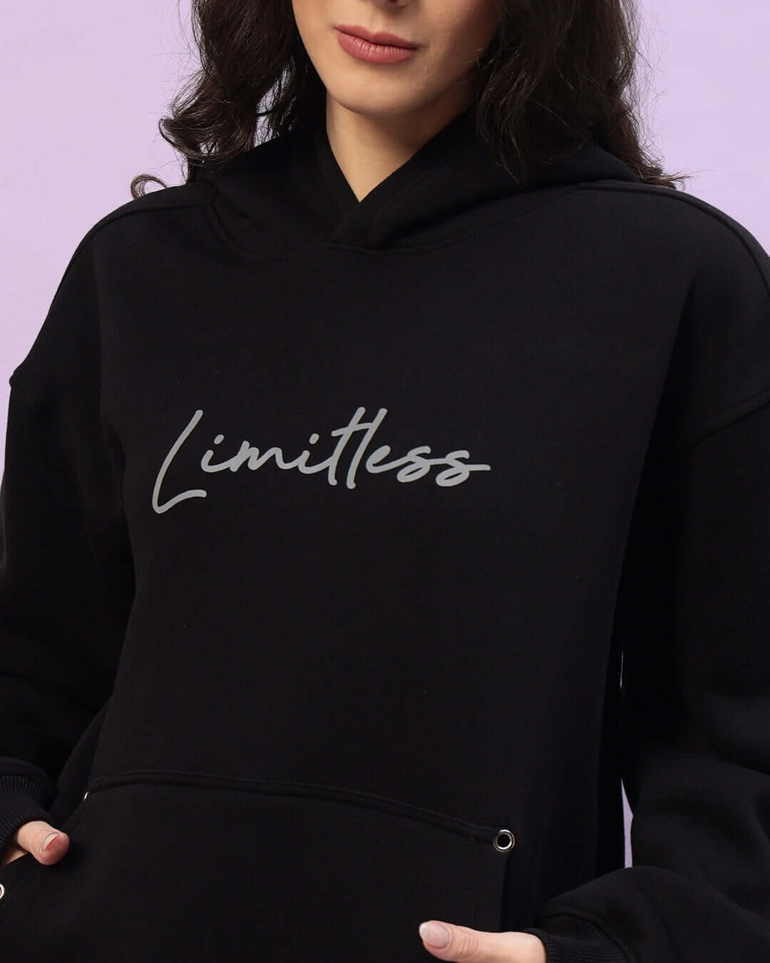 Black Women's Limitless Fleece Reflector Hoodie with stylish reflector text, designed for comfort and visibility in low light.