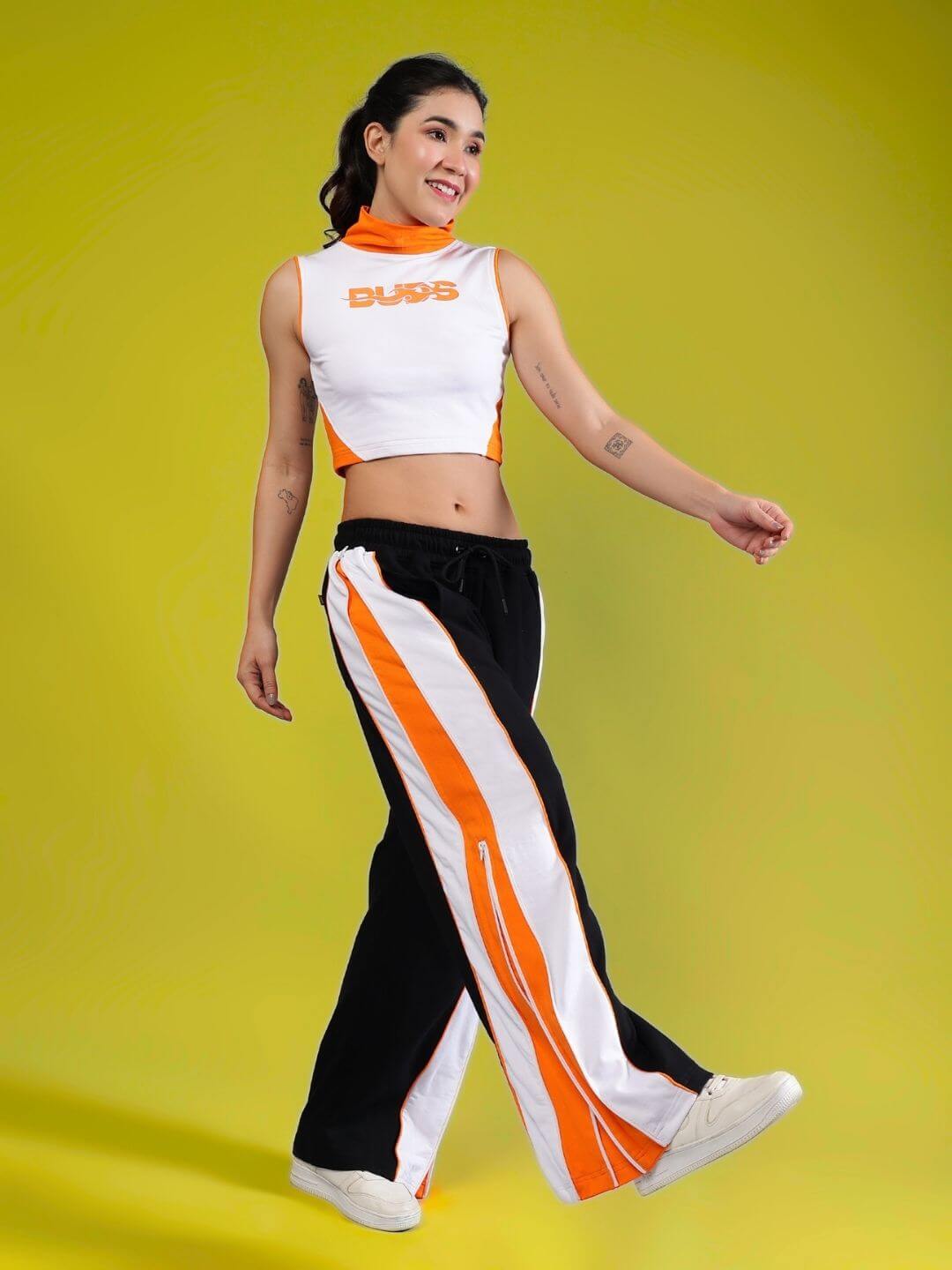 Woman wearing WOMEN'S MYSKY CO-ORD SET WHITE BLACK ORANGE by WEAR DUDS, featuring vibrant streetwear style.