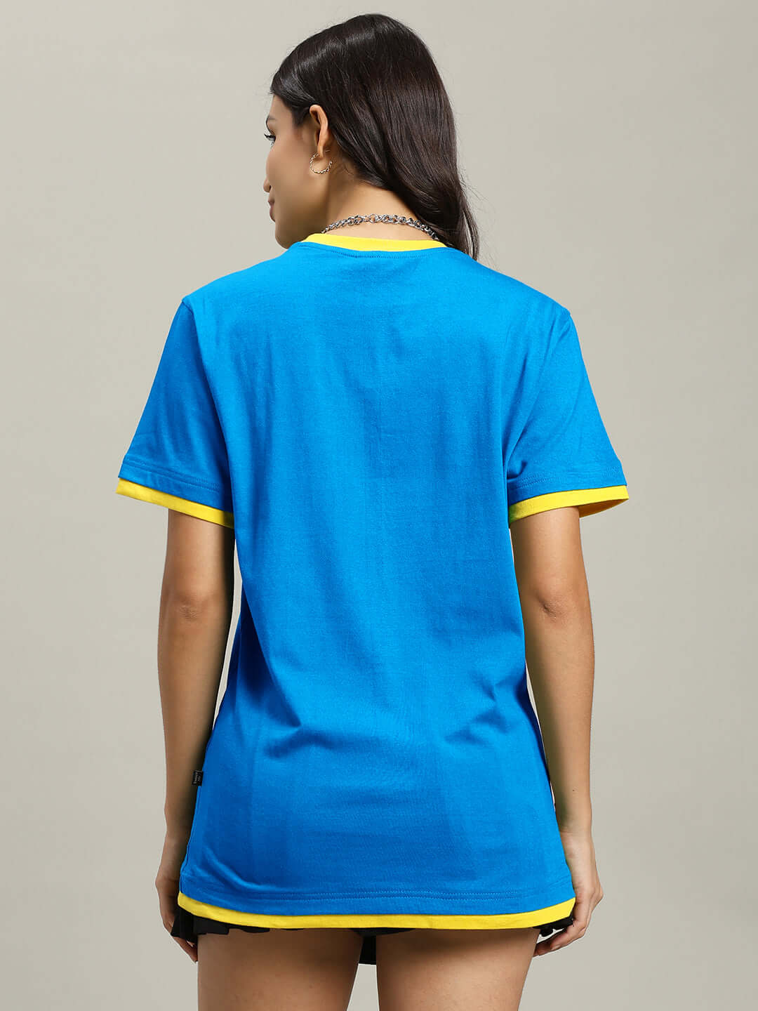 Rear view of a woman wearing a blue and yellow Women's No Risk Regular Fit T-Shirt made from 100% cotton, bio-washed for comfort.
