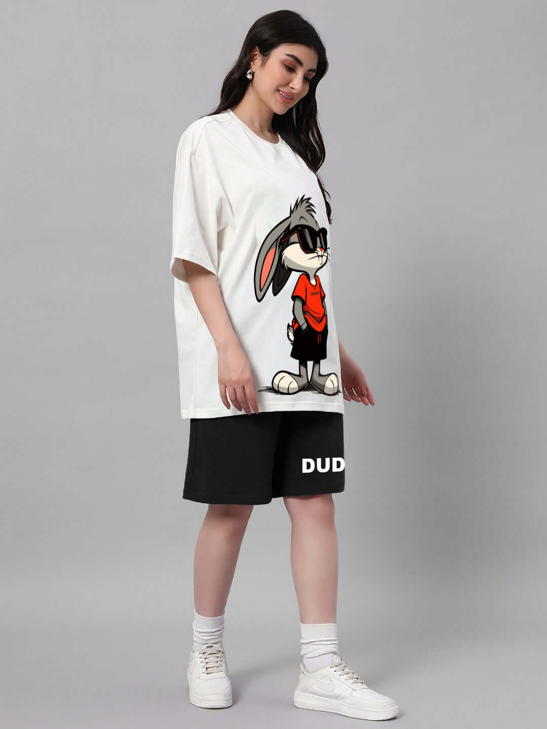 Woman wearing off-white and black Think Big Bunny Toons co-ord set with cartoon character, comfortable and stylish design.