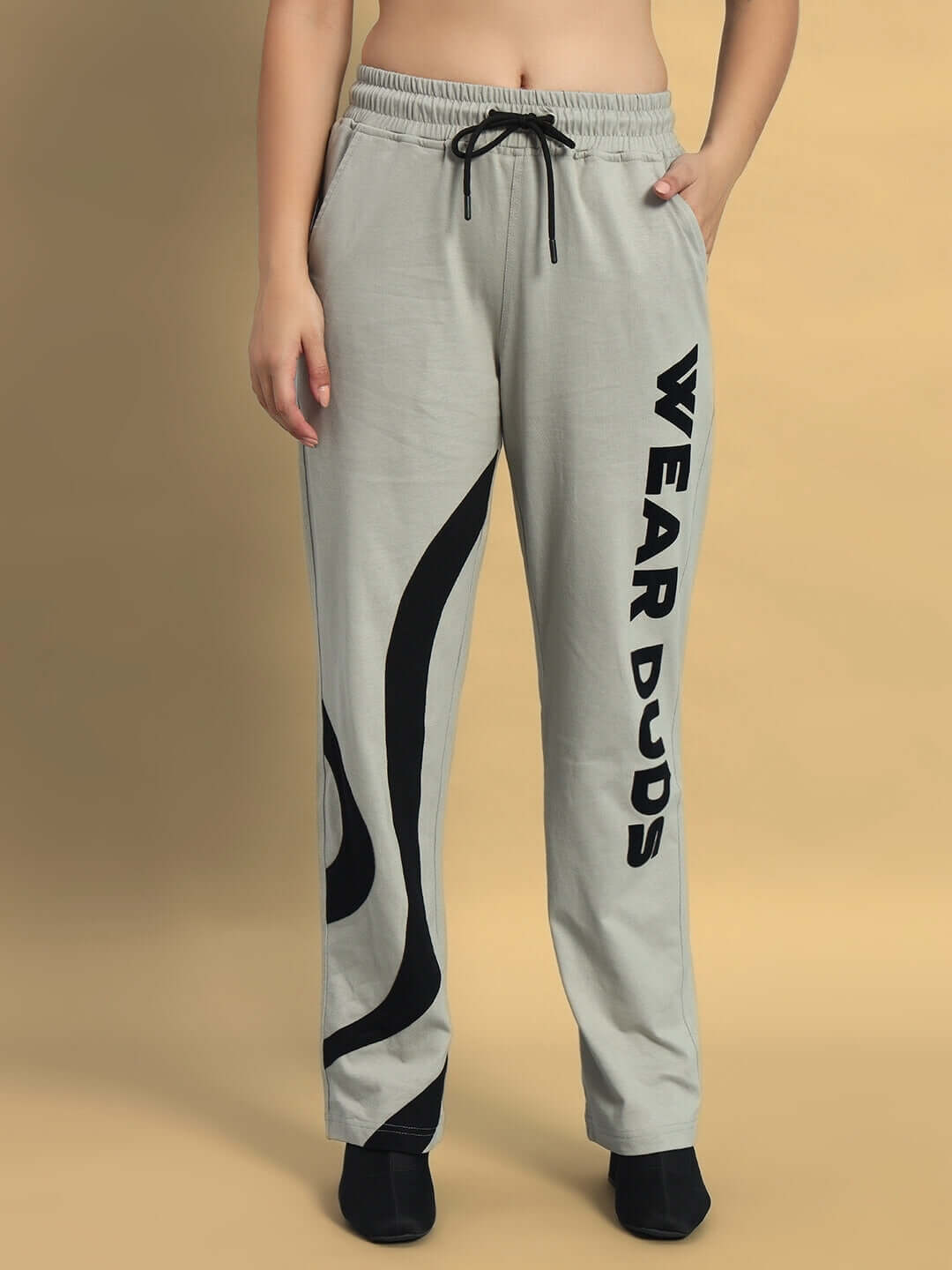 Women's grey oversized joggers with black drawstring, featuring 'Wear Duds' text and black swirl design, highlighting relaxed fit.