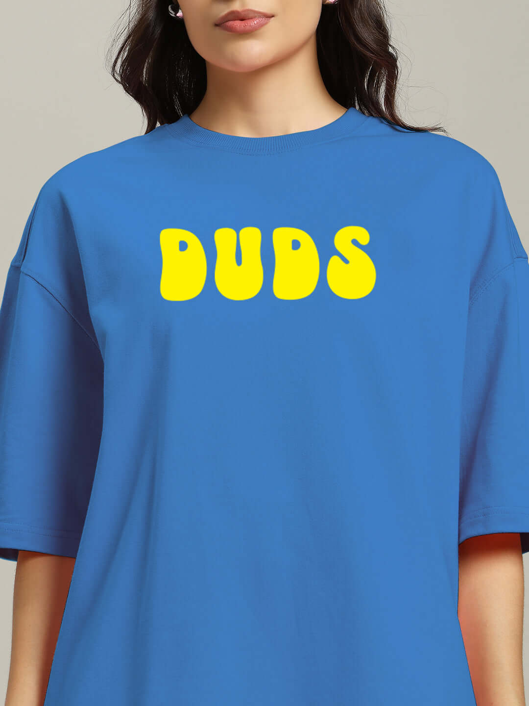 Blue oversized women's t-shirt with "DUDS" printed in yellow, made from premium French Terry cotton blend.