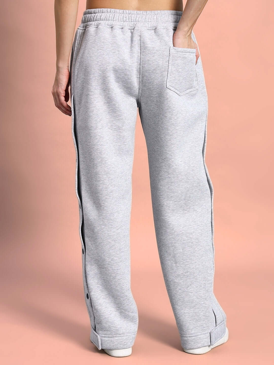 Back view of women’s grey polar fleece joggers with pocket detail, designed for comfort and style, perfect for casual wear.