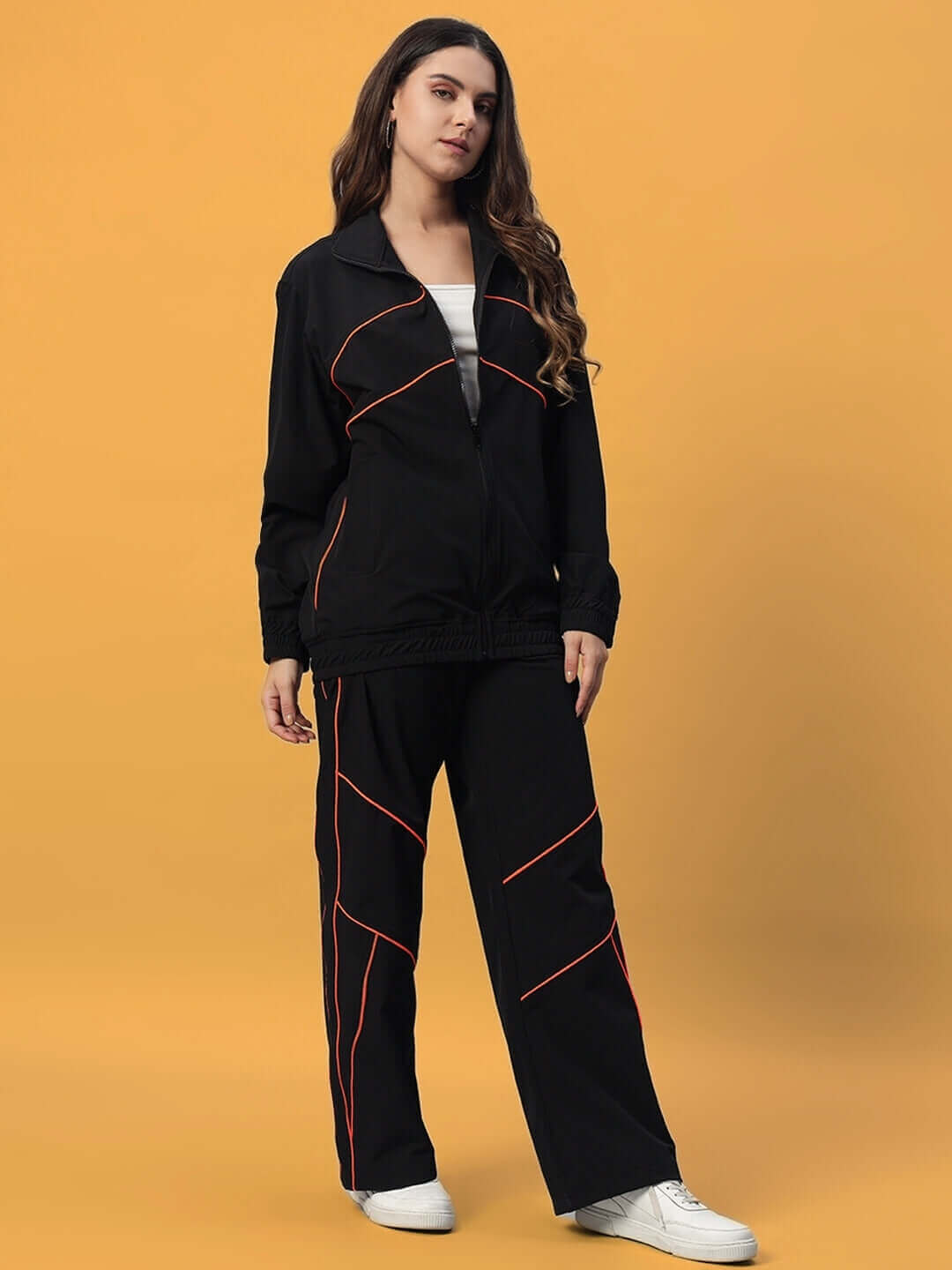 Model wearing Women's Raider Co-Ord Set in black polyester with red accents, ideal for a stylish look. Cold machine wash recommended.