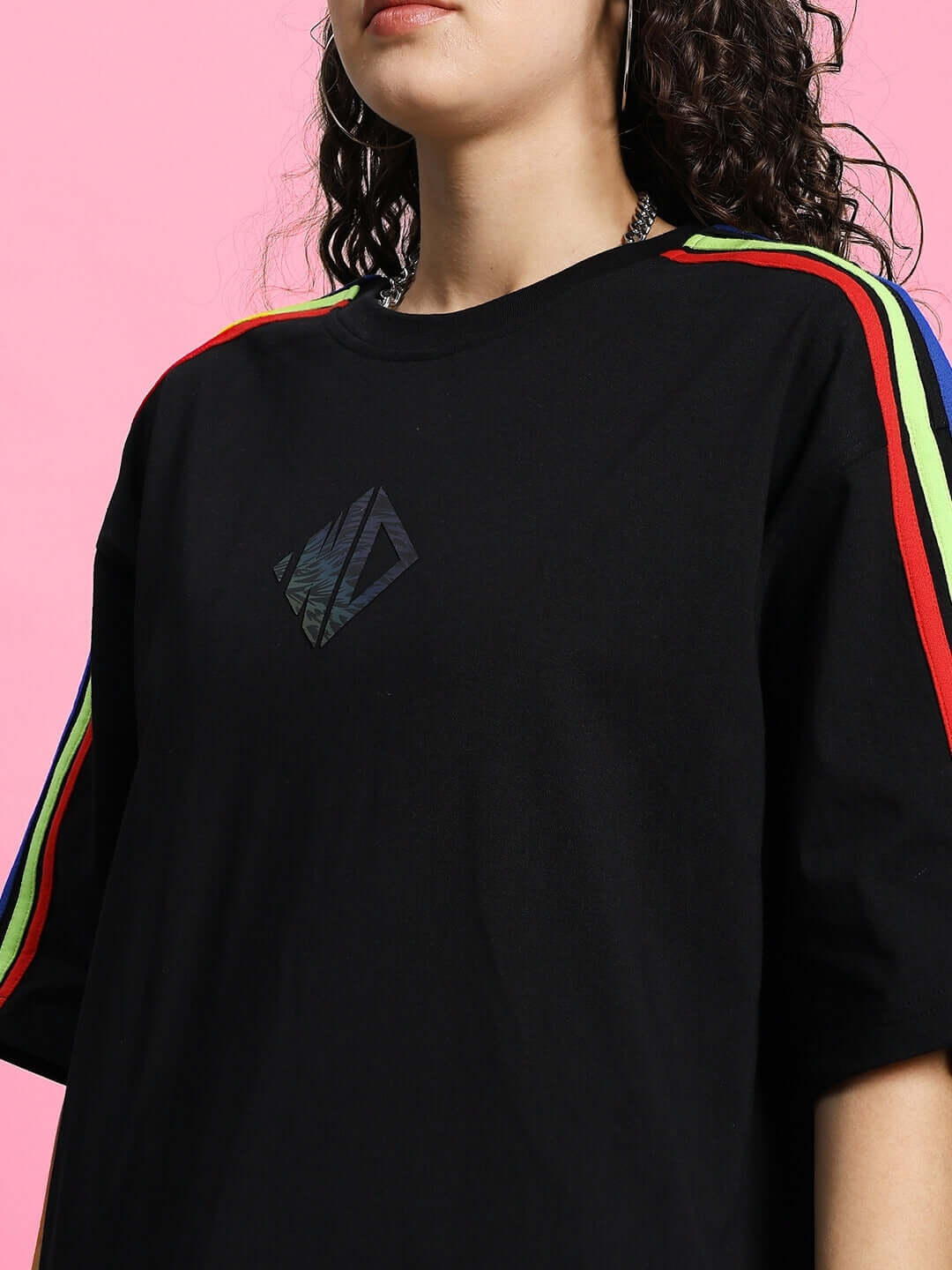 Model wearing WOMEN'S RAINBOW SUMMER CO-ORD SET BLACK with bold rainbow detailing on sleeves.