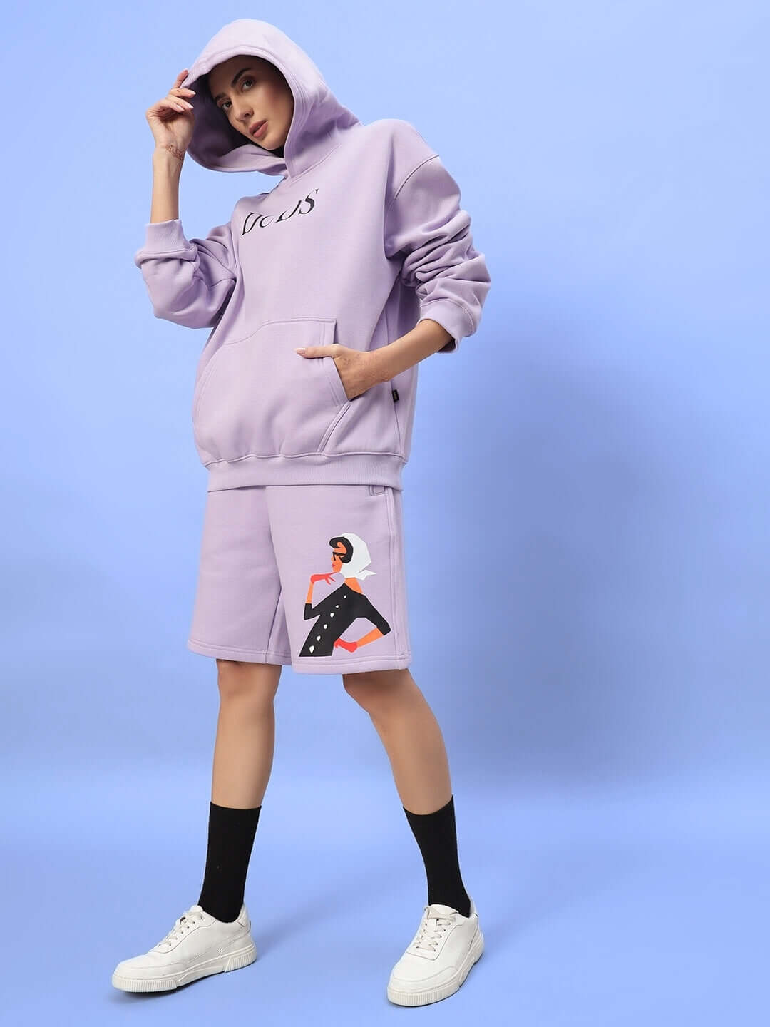 Model wearing WOMEN RITZY FLEECE HOODIE LILAC from DUDS, showcasing casual lilac hoodie with artistic design.