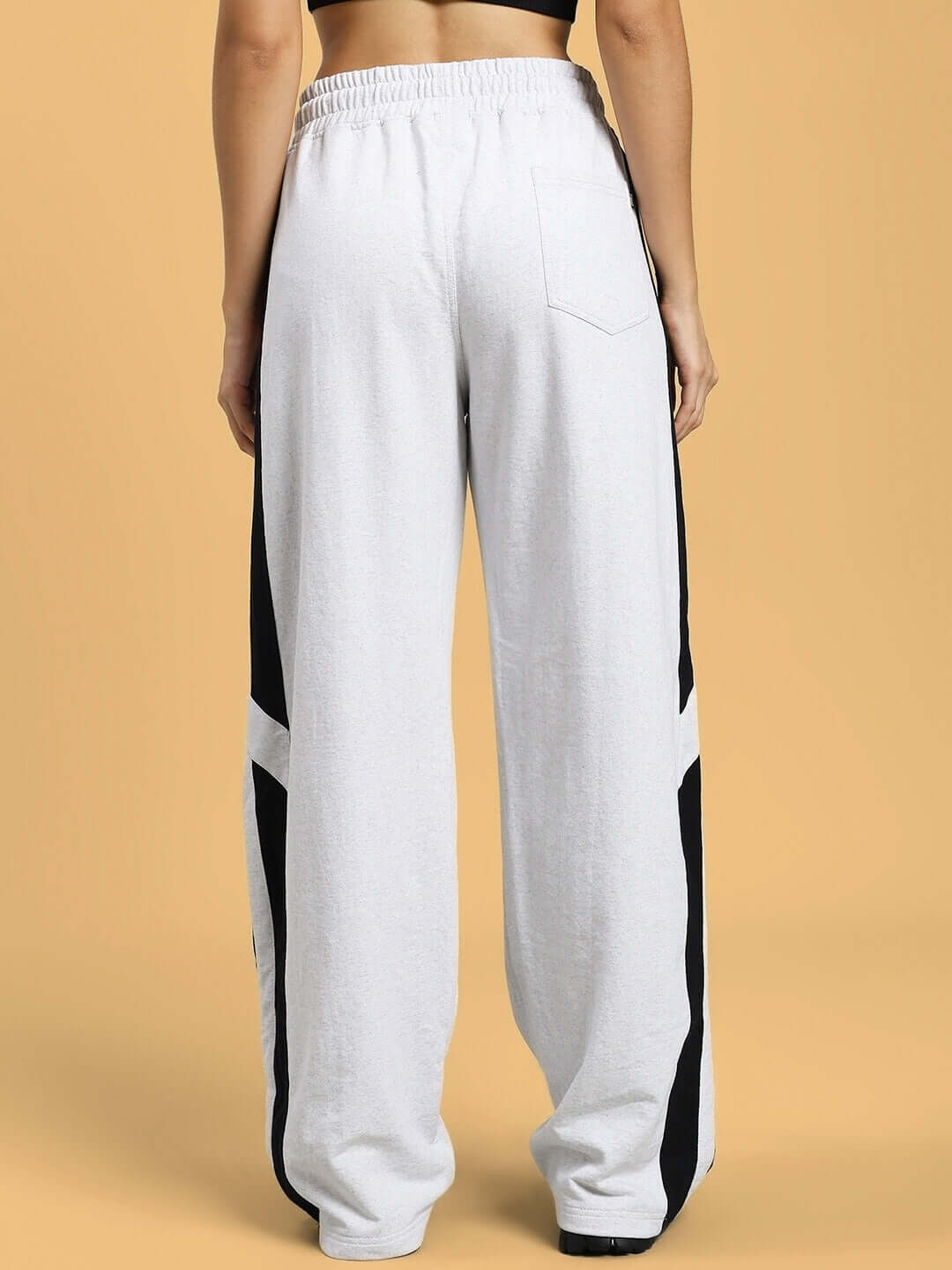 Back view of WOMEN'S ROYALSON JOGGERS MELANGE-GREY showcasing melange-grey fabric, tailored fit, black side panels, and elastic waistband.