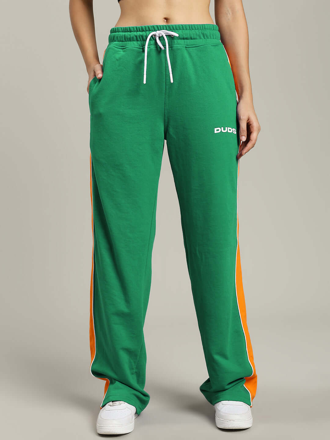 Person wearing WOMENS SANFORD STRIPE JOGGERS GREEN with side stripes, showcasing sporty style and comfort.