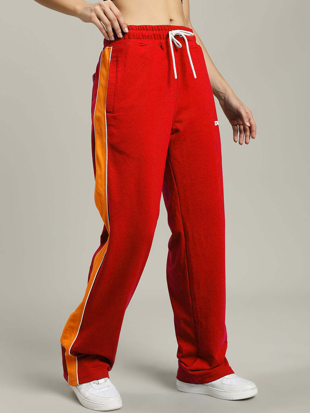 Red women's Sanford stripe joggers with orange accents and drawstring waist, made to order by DUDS.