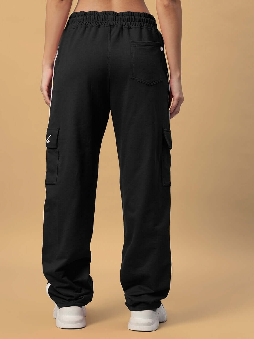 Back view of women's black Scotia Stripe joggers, featuring cargo pockets and elastic waistband, made by experienced DUDS tailors.