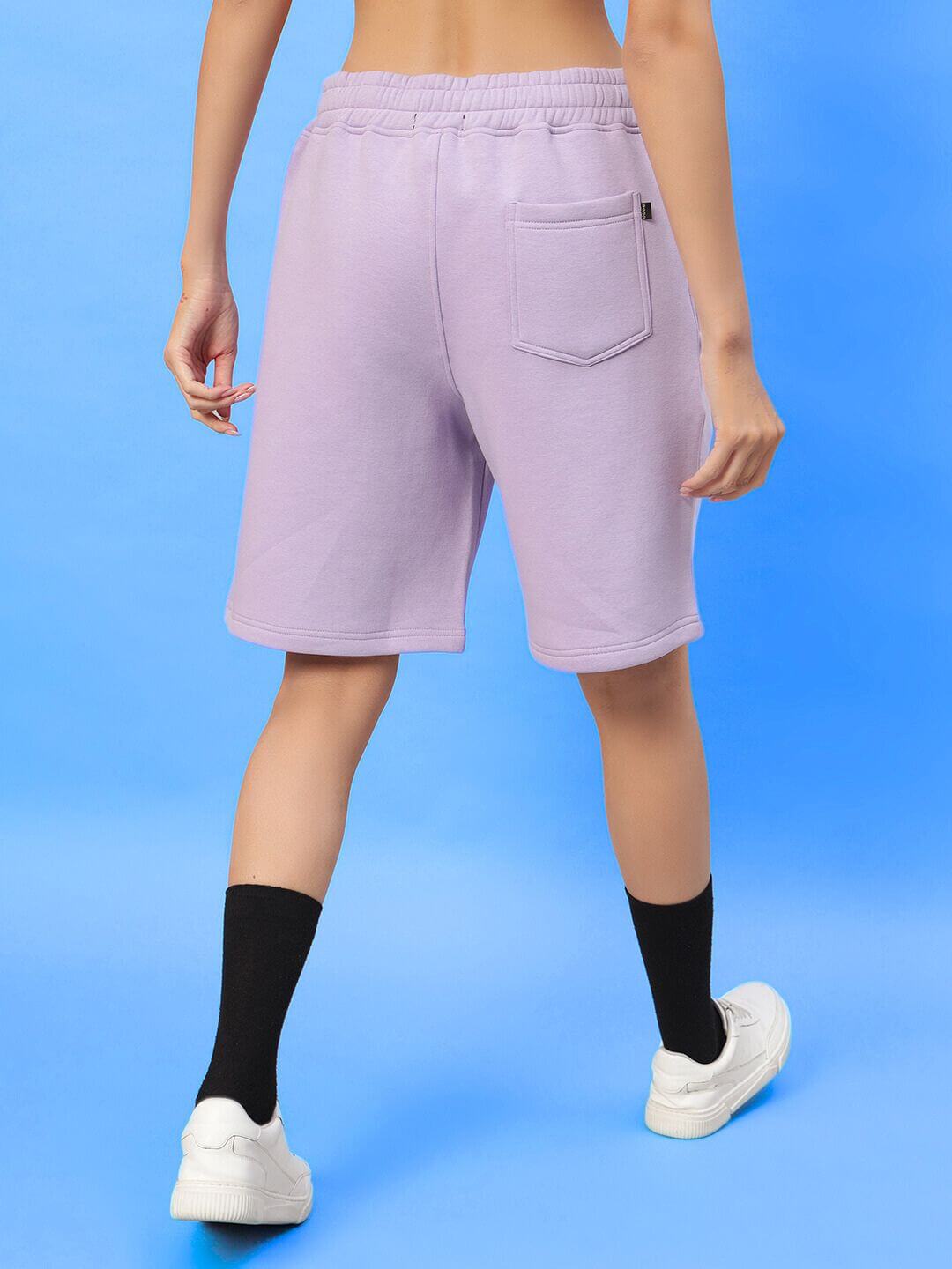 Back view of WOMENS SILENT HUG PRINTED FLEECE CO-ORD LILAC shorts in pastel lilac, showing casual fit and soft fabric.