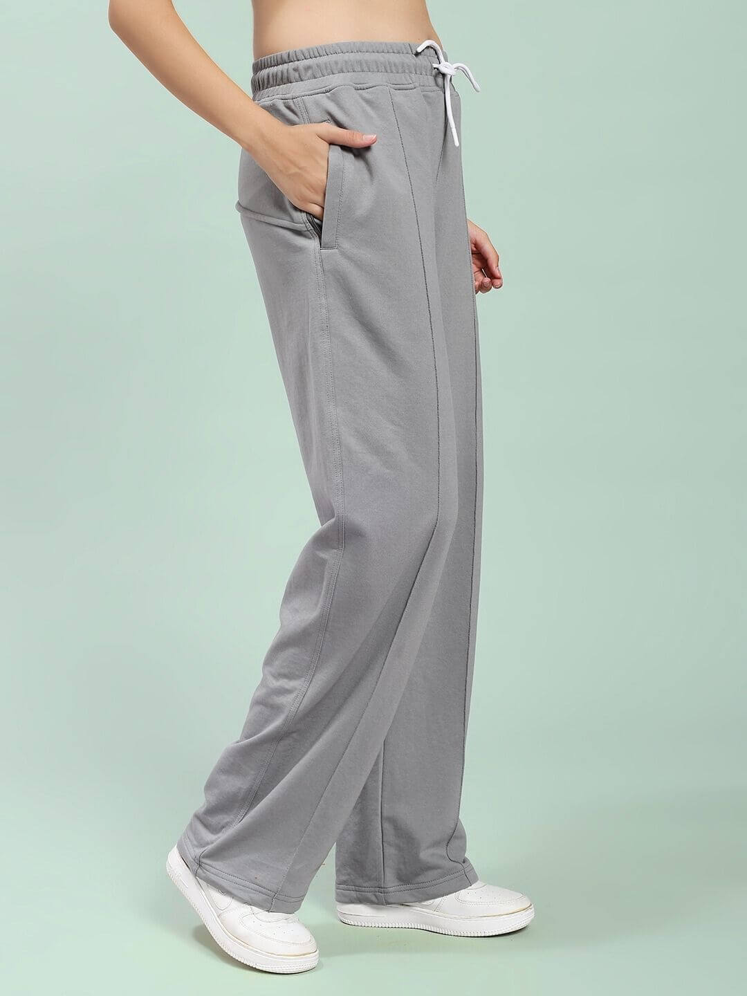 Woman wearing WOMEN SPIRAL RELAXED-FIT JOGGERS GREY, showcasing the side pockets and relaxed fit style, perfect for lounging or streetwear.