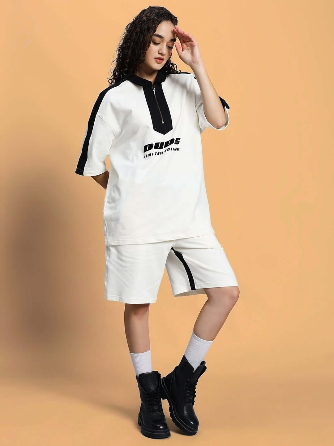 Woman wearing off-white women's Splinter summer co-ord set with shorts and top, made from premium cotton French terry fabric.