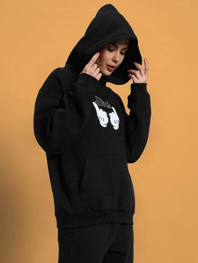 Woman wearing WOMEN SUPREME FLEECE HOODIE BLACK with hood up, featuring comfortable design and custom fit option.