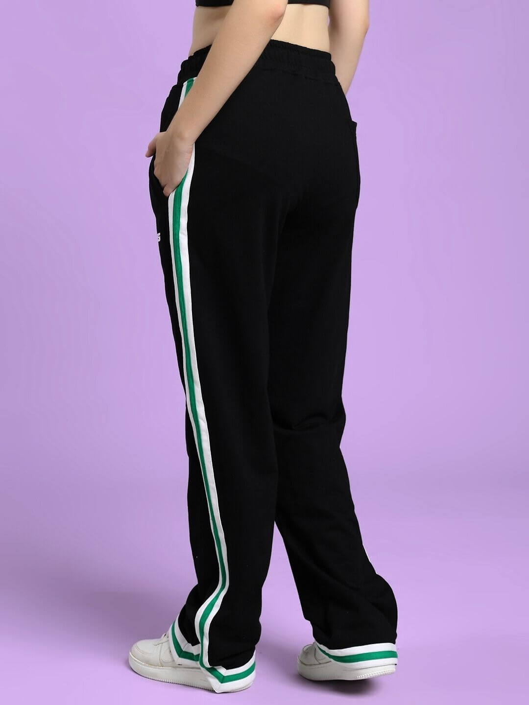 Back view of WOMEN'S VELO GREEN STRIPE RELAXED FIT JOGGER BLACK with bold green side stripe, highlighting sleek and modern design.
