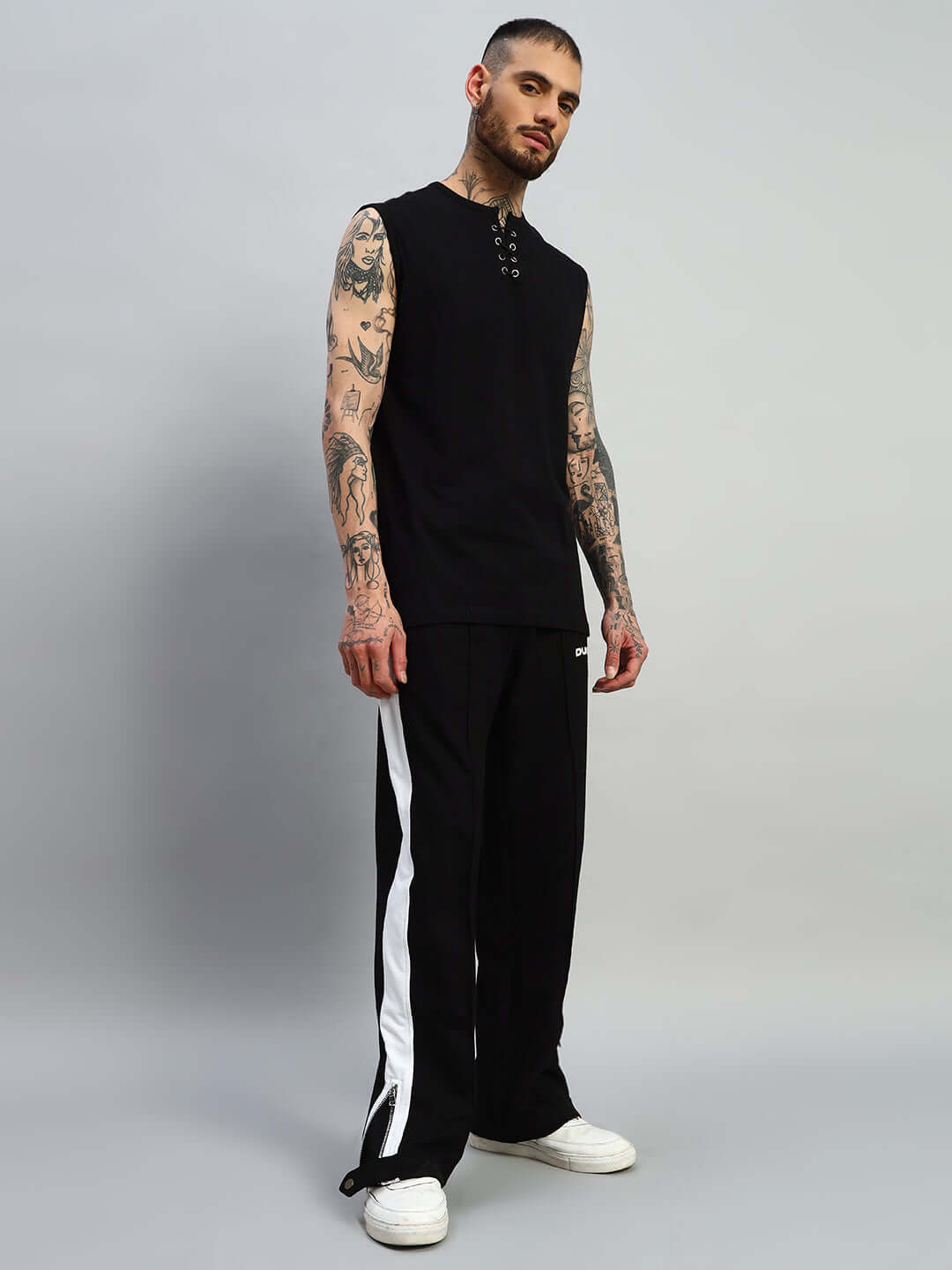 Model wearing black and white Wonder Slit Zipper Joggers by DUDS, showcasing a custom-fit option for tailored comfort.