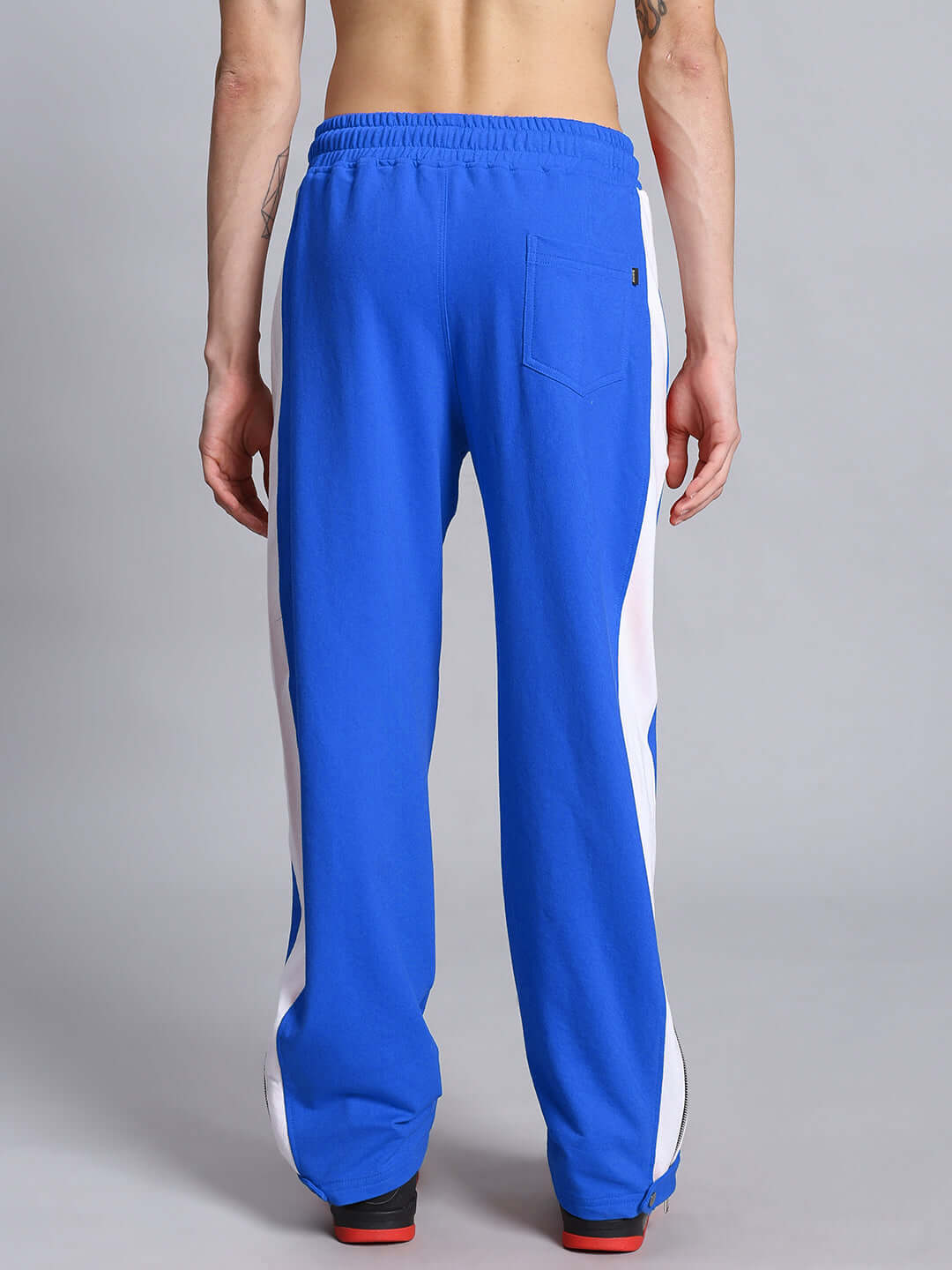 Model wearing Wonder Slit Zipper Joggers in blue and white, showcasing the stylish design and comfortable fit from the back.