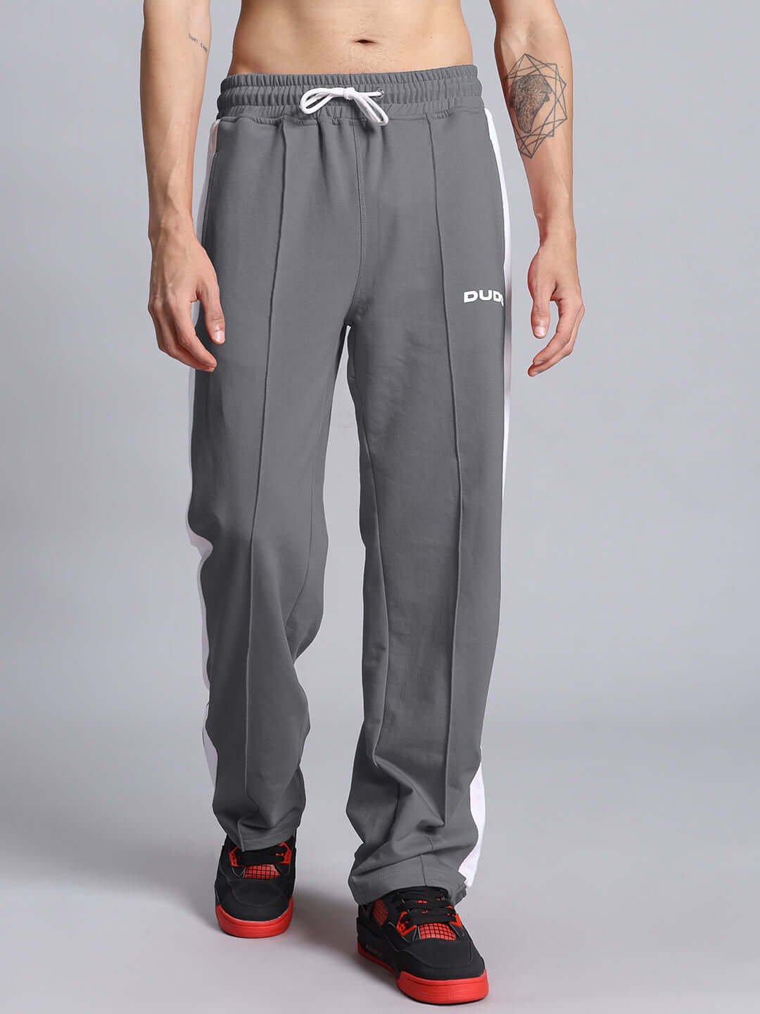 Model wearing grey and white Wonder Slit Zipper Joggers by DUDS, showcasing front view with comfortable fit and custom fit option available.