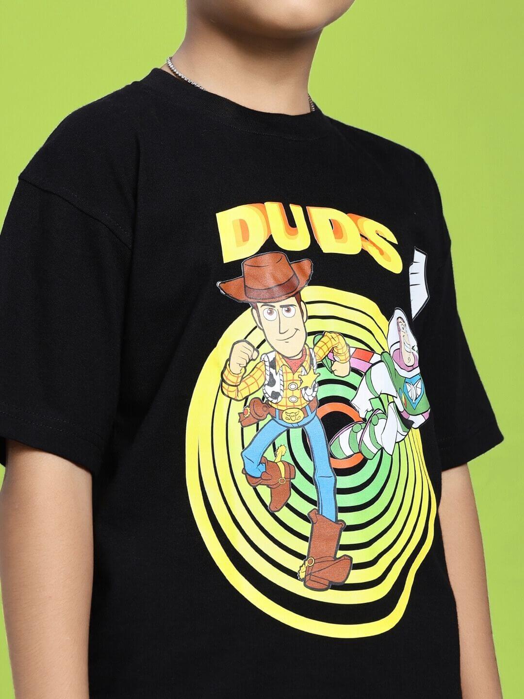 Child wearing WOODY BUZZ T-SHIRT FOR BOYS AND GIRLS BLACK with character graphic on green background