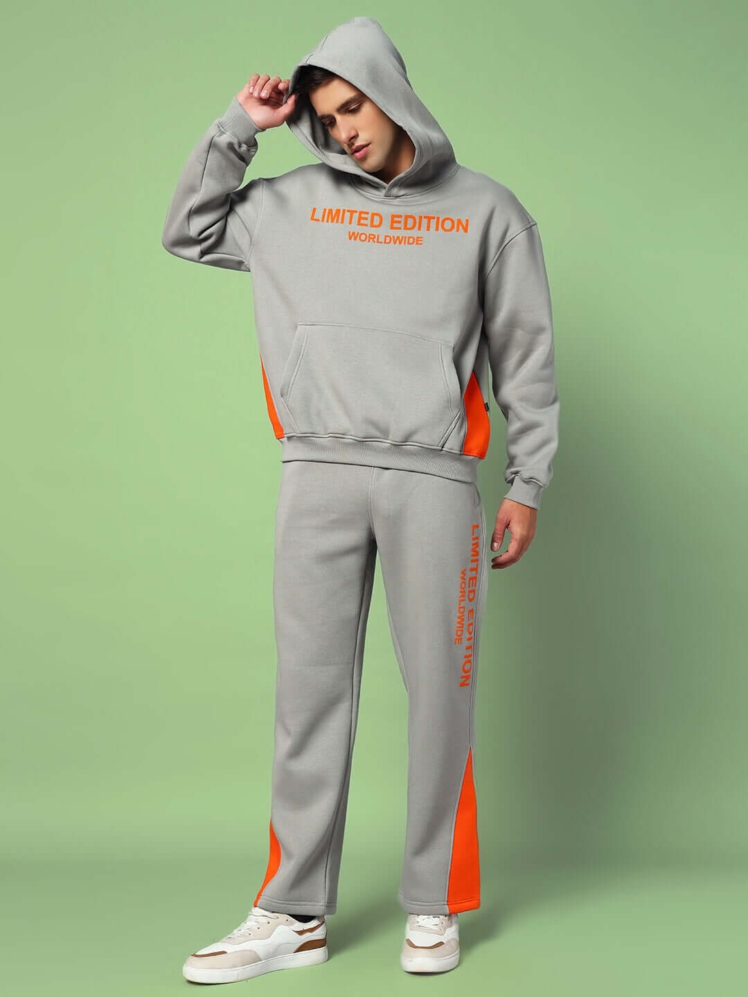 Model wearing WORLDWIDE COTTON FLEECE HOODIE GREY with relaxed fit, spacious hood, and classic kangaroo pocket, styled with matching joggers.
