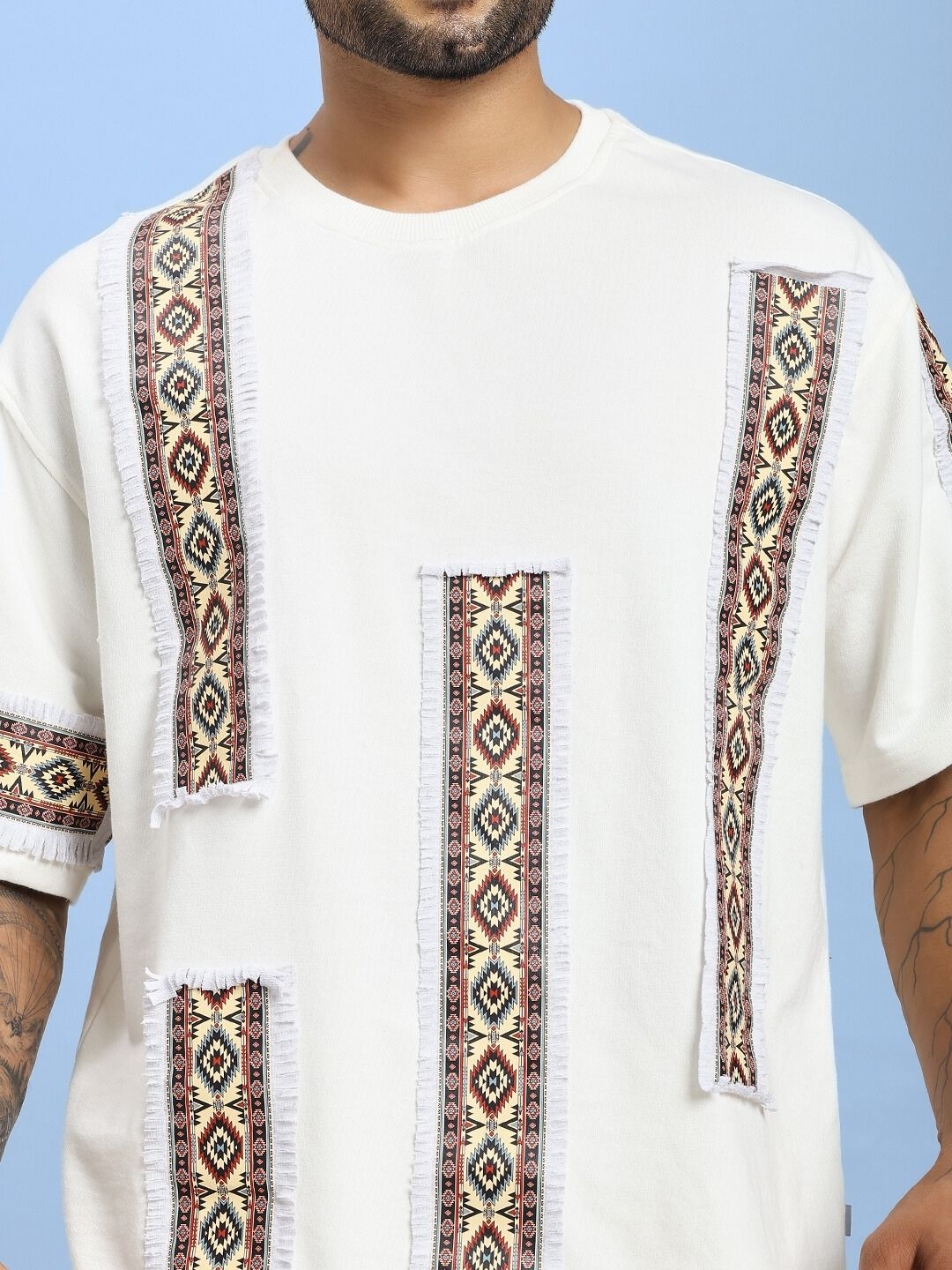 Man wearing YARA GEOMETRIC PRINT CO-ORD SET OFF-WHITE with intricate pattern design.